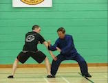 Grandmaster Wong defends an attack with the Crossroads at Four Gates pattern 'Bar the Big Boss'